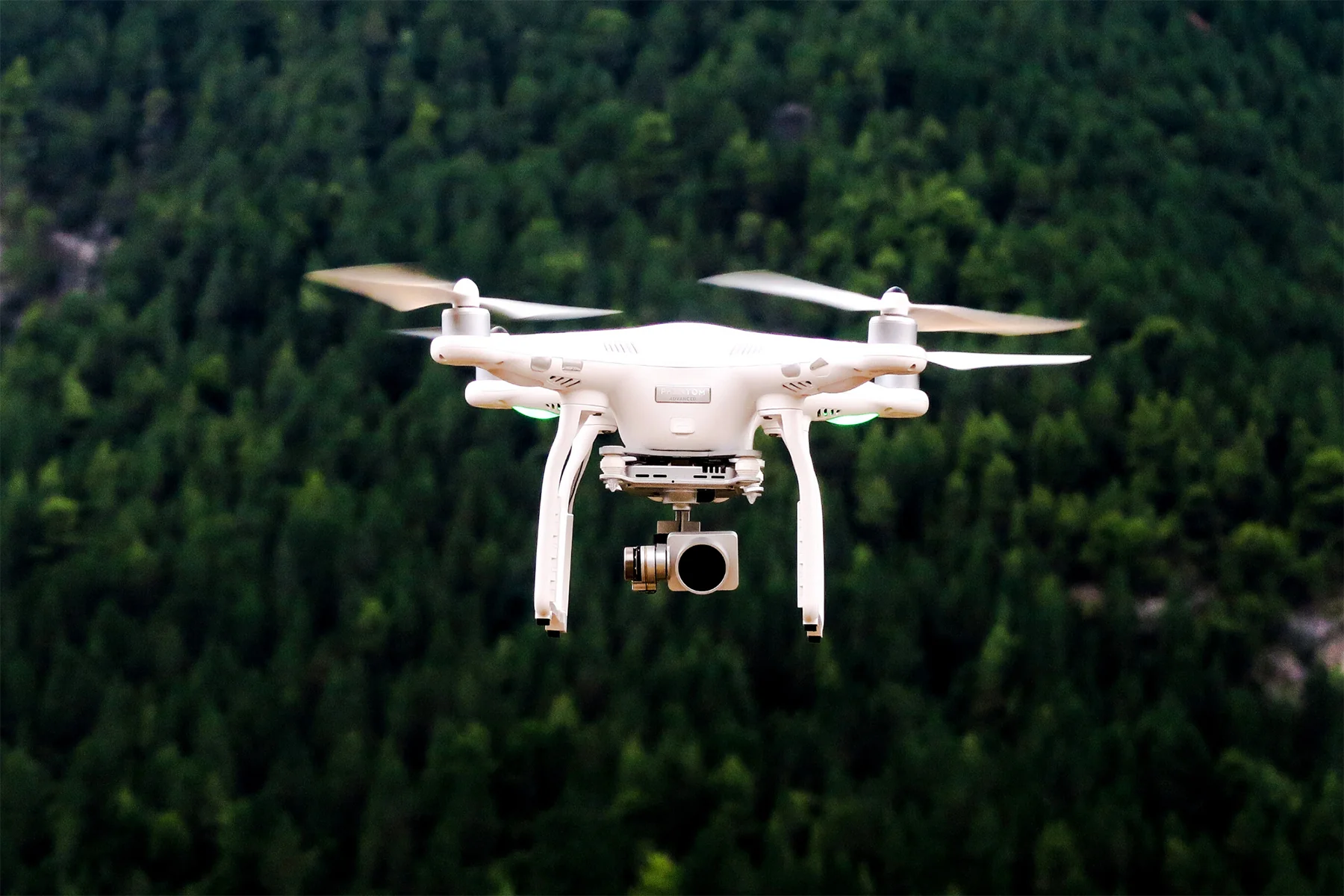 Drone in front of forest.