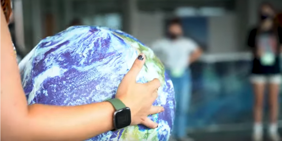 arms holding globe