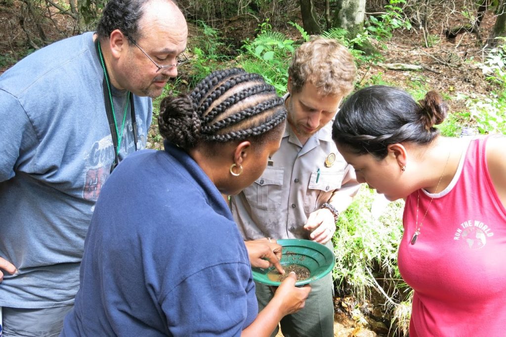Teachers examine sediment from a creek.