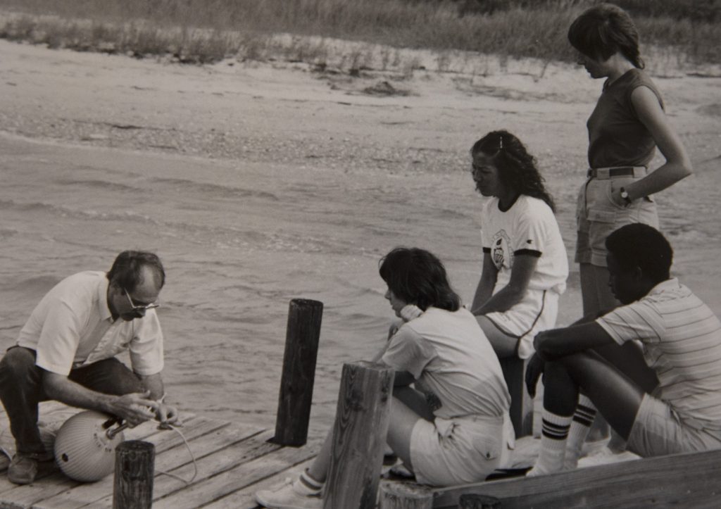 UNC marine scientist TK teaches a group of students about sediment sampling at the Institute of Marine Sciences, circa 1980. I photo courtesy University Archives