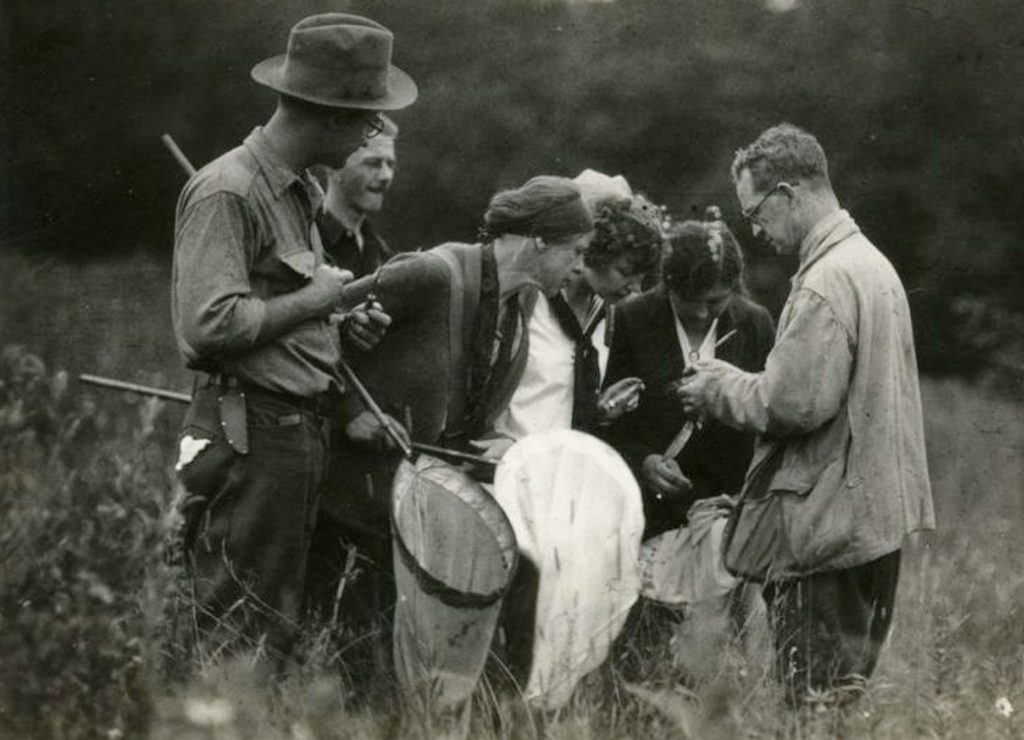 UNC zoologist Robert Coker (right) explains a research procedure to fellow scientists while out in the field, circa 1940s.